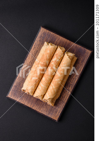 Delicious crispy wafer rolls with cream filling with nuts Delicious crispy wafer rolls with cream filling with nuts 101171309