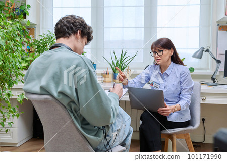 Female education center worker talking to young male college student Female education center worker talking to young male college student 101171990