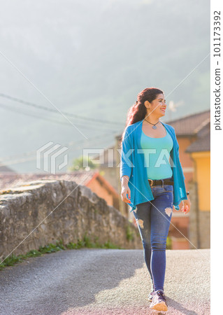 Active holiday vacation trip. Middle aged latin woman doing tourism excursion outdoor in Asturias Active holiday vacation trip. Middle aged latin woman doing tourism excursion outdoor in Asturias 101173392