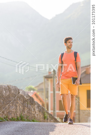 Indian mid man in Asturias summer vacation. Casual hiker adventure with backpack. Ecotourism 101173395