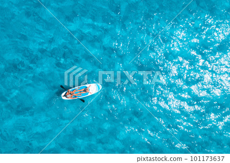 Aerial view of sup board with people in blue sea at sunny day 101173637