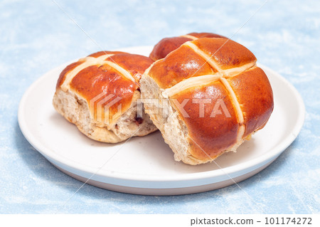 Freshly baked hot cross buns on white plate. Traditional easter food, horizontal Freshly baked hot cross buns on white plate. Traditional easter food, horizontal 101174272