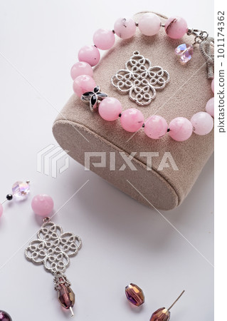 author bracelet with natural cherry jasper and details against white background. fashion and jewelry concept 101174362