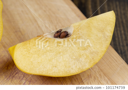 Sliced ripe yellow quince on a cutting board 101174739