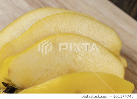 Sliced ripe yellow quince on a cutting board 101174743