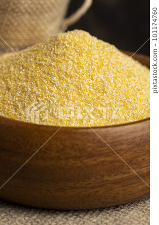 Round wooden bowl with dry corn flour Round wooden bowl with dry corn flour 101174760