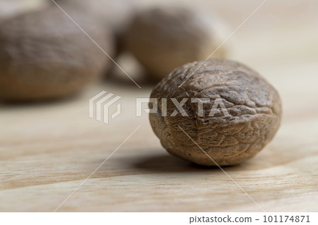 A whole nutmeg fruit on the kitchen table A whole nutmeg fruit on the kitchen table 101174871