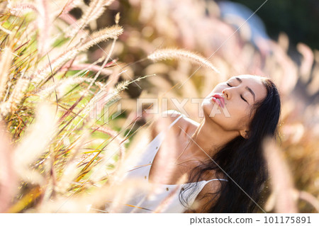 Fashion close-up portrait of young woman posing at grassplot Fashion close-up portrait of young woman posing at grassplot 101175891