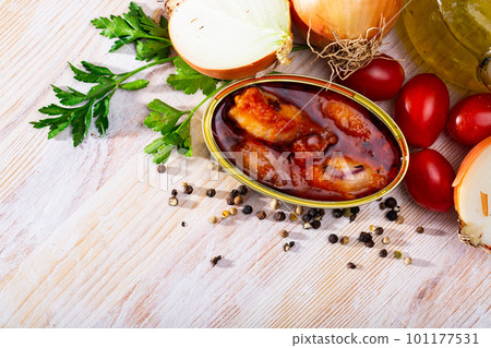 Stuffed squid in tomato sauce on background with greens, tomatoes 101177531