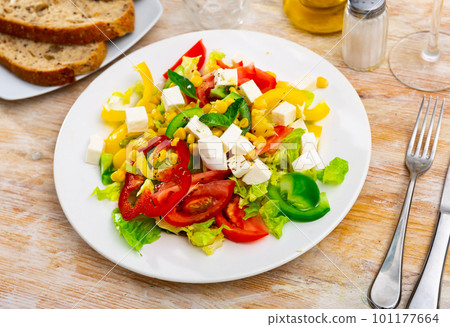 Salad with cheese, tomato, peppers, and corn Salad with cheese, tomato, peppers, and corn 101177664