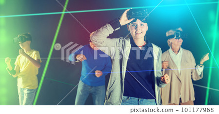 Teenage girl using virtual reality glasses with family 101177968