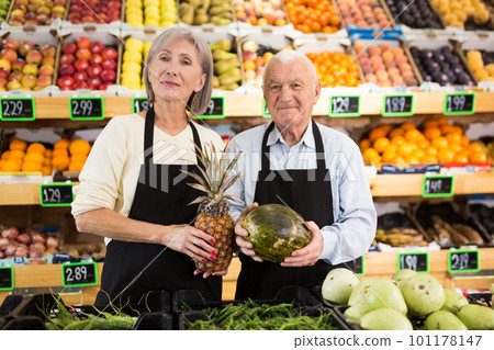 Mature supermarket workers standing in salesroom 101178147