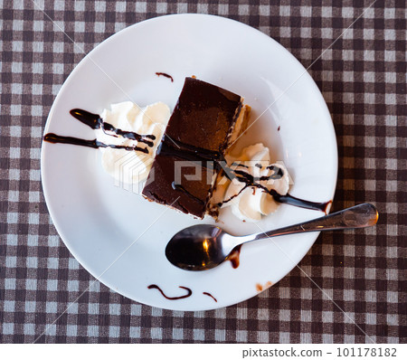 Dessert Bird's milk with chocolate and whipped cream 101178182
