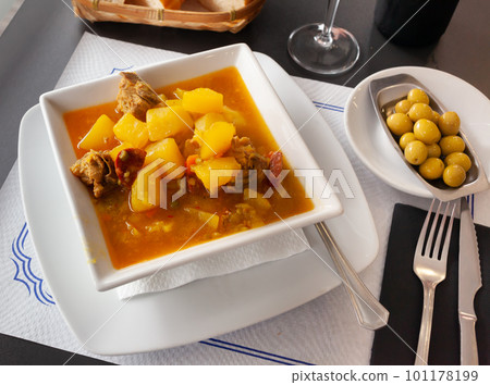 Spanish dish - ribs and chorizo sausage with potatoes 101178199