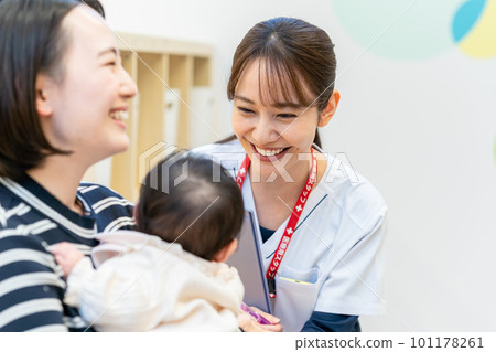 Young nurse and baby working in hospital 101178261
