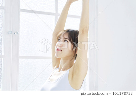 Young woman stretching in the room Young woman stretching in the room 101178732