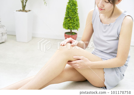 Woman taking care of her knees at home Woman taking care of her knees at home 101178758