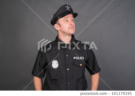 Portrait of Caucasian man wearing police uniform costume 101179195