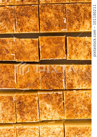 Homemade eggnog fudge pieces on a white cutting board. Homemade eggnog fudge pieces on a white cutting board. 101180211