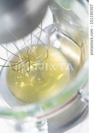 Whipping egg whites in a stand electric mixer to bake meringue cookies. Whipping egg whites in a stand electric mixer to bake meringue cookies. 101180307