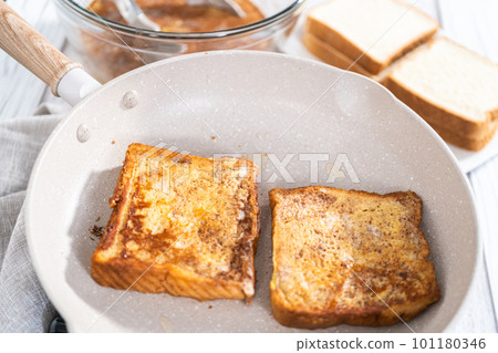 Frying french toast in a nonstick frying pan. Frying french toast in a nonstick frying pan. 101180346