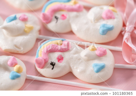 Gourmet unicorn theme meringue pops on a pink background. Gourmet unicorn theme meringue pops on a pink background. 101180365