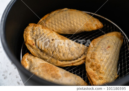 Frying sweet cherry empanadas in the air fryer. 101180395