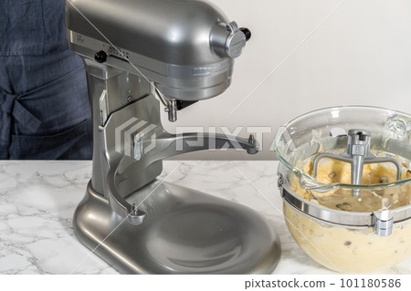 Mixing ingredients in kitchen mixer to bake mini Easter bread kulich. Mixing ingredients in kitchen mixer to bake mini Easter bread kulich. 101180586