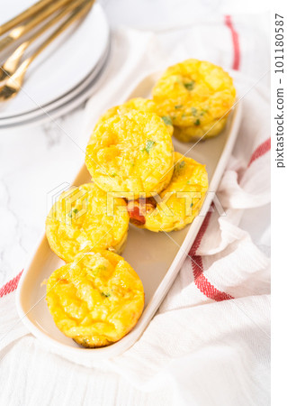 Bacon and cheese egg muffin on a white serving plate. 101180587