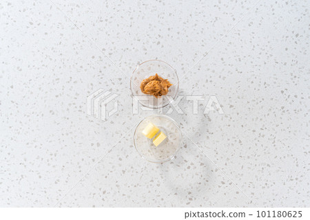 Flat lay. Measured ingredients in glass mixing bowls to make chocolate peanut butter fudge. Flat lay. Measured ingredients in glass mixing bowls to make chocolate peanut butter fudge. 101180625
