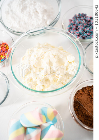 Measured ingredients in glass mixing bowls to make unicorn hot chocolate mix. Measured ingredients in glass mixing bowls to make unicorn hot chocolate mix. 101180642