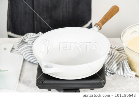 Trying coconut banana pancakes on a nonstick white frying pan. Trying coconut banana pancakes on a nonstick white frying pan. 101180648