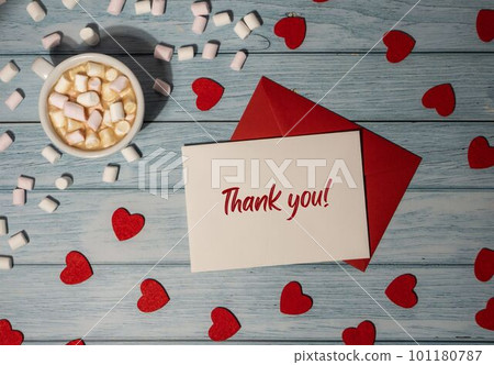 THANK YOU text on valentine card inscription positive quote phrase Greeting card with red envelope with white cup of coffee and marshmallows on wooden background. Romantic Small hearts Valentine day THANK YOU text on valentine card inscription positive quote phrase Greeting card with red envelope with white cup of coffee and marshmallows on wooden background. Romantic Small hearts Valentine day 101180787