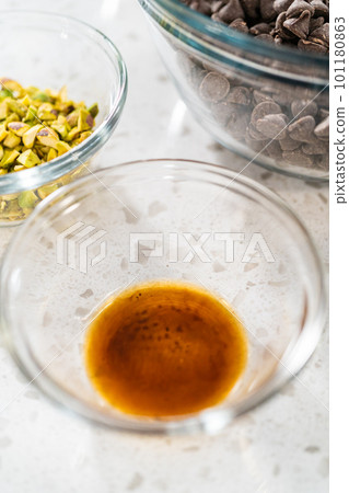 Measured ingredients in glass mixing bowls to make chocolate pistachio fudge. 101180863