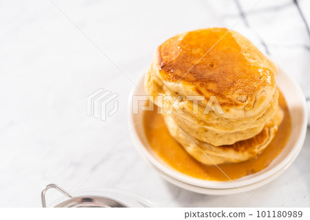 Stack of eggnog pancakes with drizzled eggnog caramel sauce on top. Stack of eggnog pancakes with drizzled eggnog caramel sauce on top. 101180989