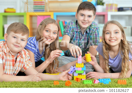 Children playing together floor with green carpet 101182627