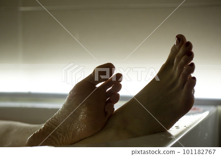 Feet in the bathroom closeup. Steamed female heels. Manicure. 101182767
