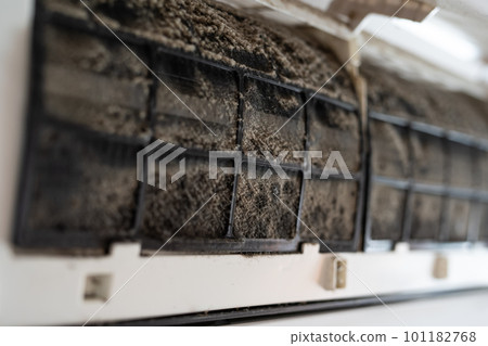 Dirty in dust and mold air conditioner filter close-up. Home air conditioner maintenance. 101182768