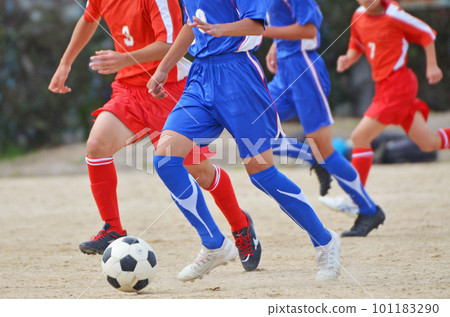 Youth soccer match (player dribbling) 101183290