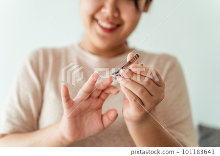 Woman cutting fingernails using nail clipper, Healthcare, Beauty Concept. Woman cutting fingernails using nail clipper, Healthcare, Beauty Concept. 101183641