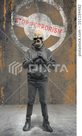 A man wearing a mask standing with a stop terrorism sign A man wearing a mask standing with a stop terrorism sign 101184482
