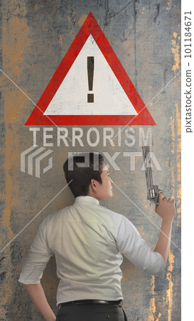Rear view of a businessman holding gun with a stop terrorism sign Rear view of a businessman holding gun with a stop terrorism sign 101184671