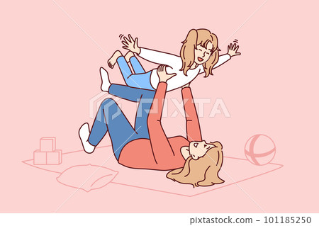 Caring mother lying on floor lifts laughing daughter enjoying playing with child 101185250