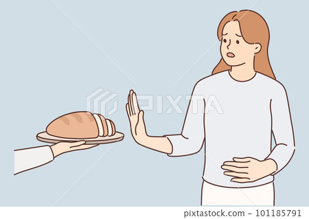 Frustrated woman holding on to stomach refuses bread due to allergies and gluten intolerance 101185791
