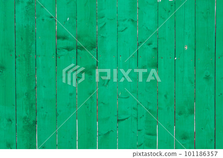 background, a fence made of green boards 101186357