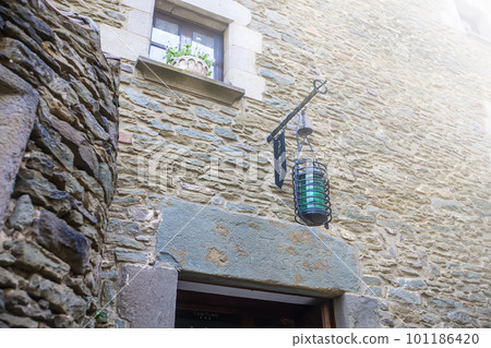 Old original lamp on the stone wall of the castle Old original lamp on the stone wall of the castle 101186420