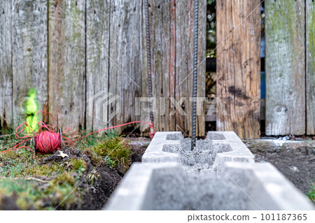 the foundation of the house is made of concrete blocks bound with metal armature 101187365