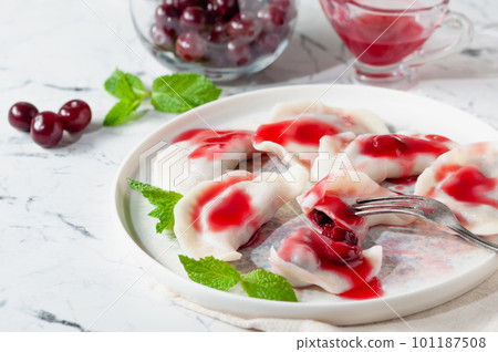 Sweet cherry dumplings served with cherry sauce. Sweet cherry dumplings served with cherry sauce. 101187508