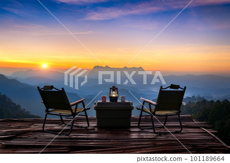 Outdoor camping table set at sunrise. Doi Luang Chiang Dao mountains in Chiang Mai. 101189664