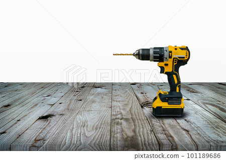 Power drill or Cordless screwdriver with battery for professional work in wooden background. 101189686